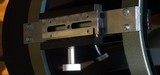 the repaired dovetail clamp mounted between the telescope tube rings